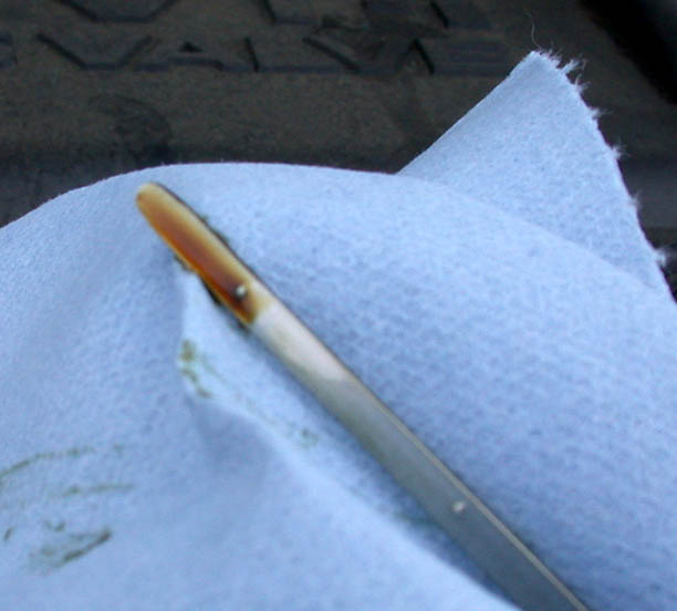 Engine oil dipstick showing the oil level